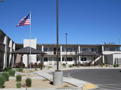 Exterior view of River's Edge Assisted Living with outdoor seating