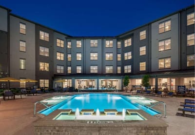 Exterior view of the facility building with pool area