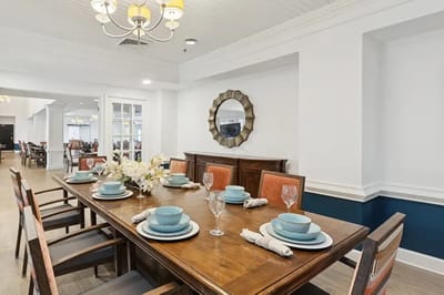 A beautifully set dining table with dishes and flowers