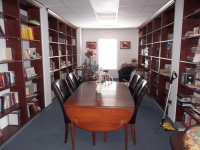 Interior view of a library with bookshelves and table