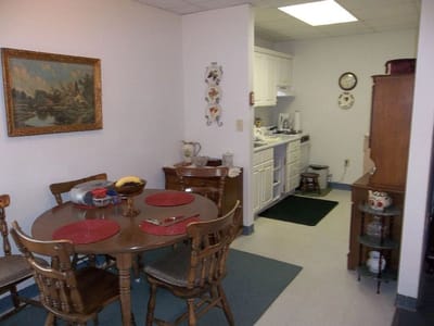 Cozy dining area with a small table and kitchen in background