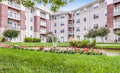 Serene courtyard with a fountain and flowers.