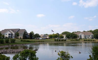 Scenic view of Hawthorn Court's exterior and pond.