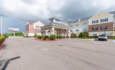Exterior view of the facility entrance and parking lot.