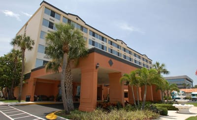 Exterior view of the facility with palm trees