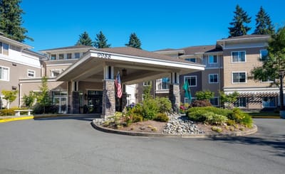 Entrance of a nursing home facility with landscaping.