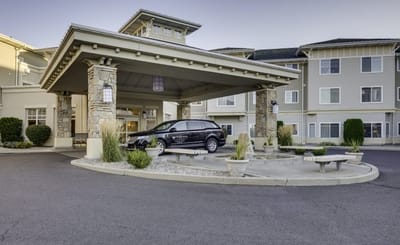 Covered entrance with vehicle at nursing home entrance.