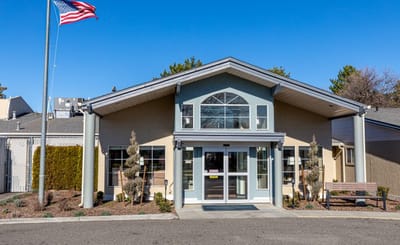 Exterior view of the facility with flag and entrance