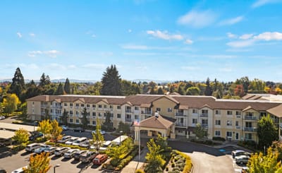 Exterior view of assisted living facility with landscaping.