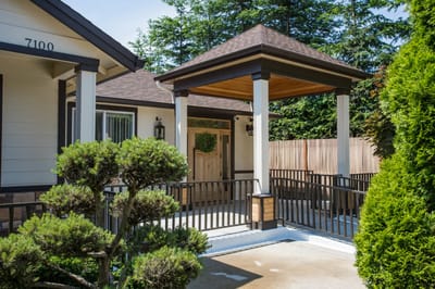 Entrance area with covered porch and garden
