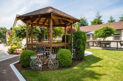 Outdoor gazebo with seating and landscaped garden