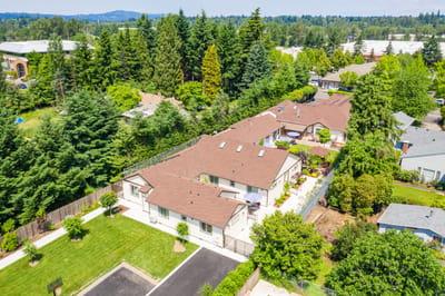 Aerial view of Mapleview Manor surrounded by greenery.