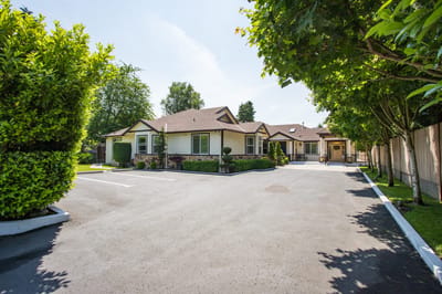 Exterior view of Mapleview Manor with landscaped area