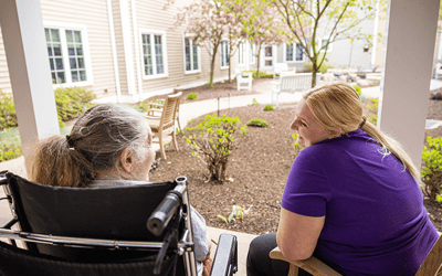 Resident and staff enjoying the outdoor garden area.