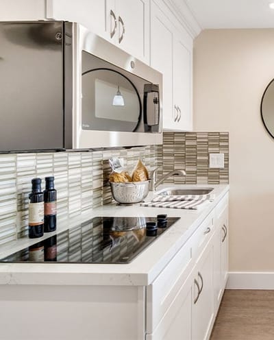 Modern kitchen with appliances and decor.