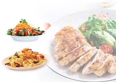 Plates of pasta, salad, and chicken dishes