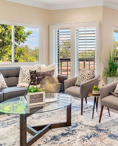 Bright interior common area with couches and plants.