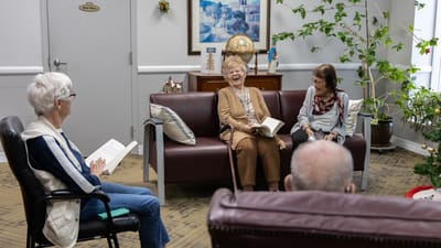 Residents engaged in conversation in a common area.