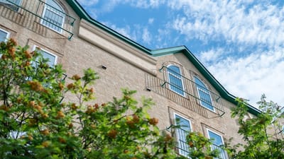 Exterior view of Riverside Manor with landscaping
