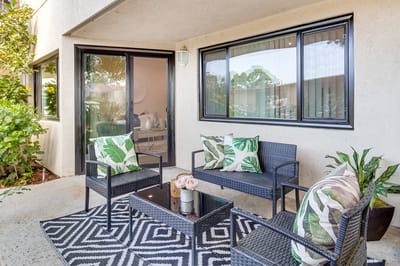 Cozy outdoor seating area with plants.