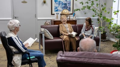 Residents engaged in conversation in a common area.