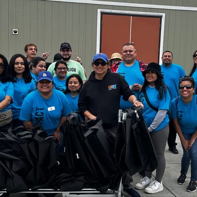 Group of smiling staff and residents outdoors