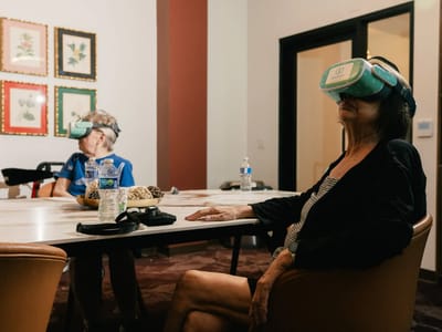 Residents enjoying virtual reality activities in a common area.