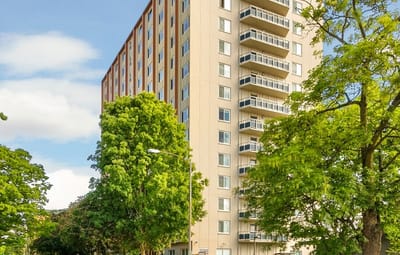 Exterior view of Hadley Villas building surrounded by trees.