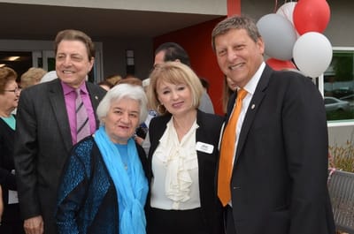 Residents and staff celebrating at an outdoor event.