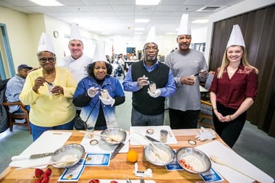 Residents and staff enjoying a cooking activity