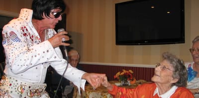 Resident enjoying a performance from an entertainer