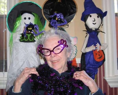 Senior woman enjoying Halloween decorations.