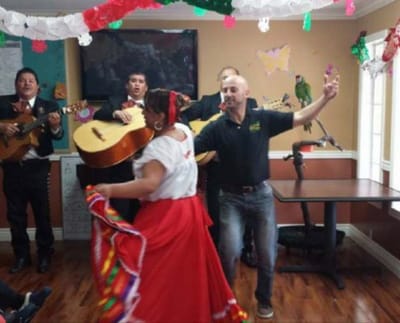 Residents enjoying a live performance with music and dance.