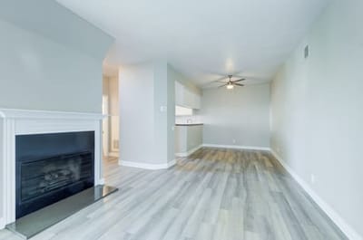 Empty living room with modern decor and wood flooring.