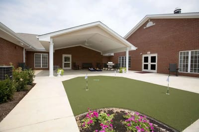 Outdoor patio area with seating and putting green.
