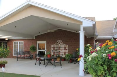 Outdoor seating area with vibrant flowers