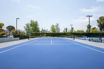 Outdoor tennis court with bright blue surface