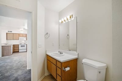 Interior view of a bathroom with beige walls and a mirror