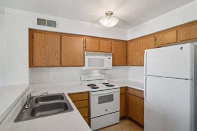Bright, clean kitchen area with appliances