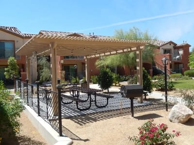 Outdoor shaded seating area with picnic tables