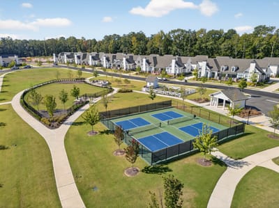Aerial view of outdoor recreational spaces and tennis courts