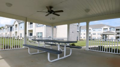 Covered outdoor seating area with picnic tables