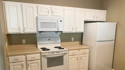 Interior kitchen with white cabinets and appliances