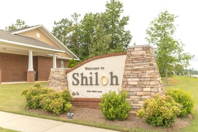 Welcome sign for Shiloh Apartments at the entrance