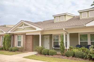 Exterior view of a senior living facility with landscaped gardens
