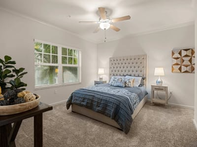 Well-decorated private resident room with a cozy bed