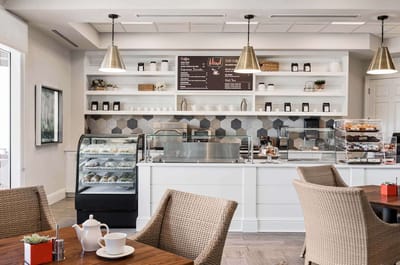 A cozy dining area with a coffee station and pastries