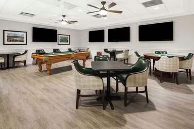 Interior of a recreation room with billiards and tables