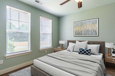 Brightly decorated bedroom with a bed and artwork