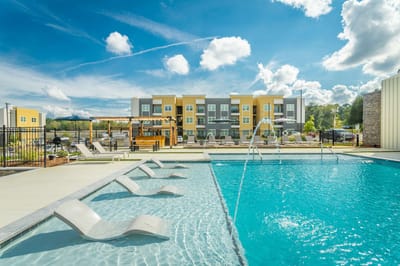 Outdoor swimming pool area with lounge chairs